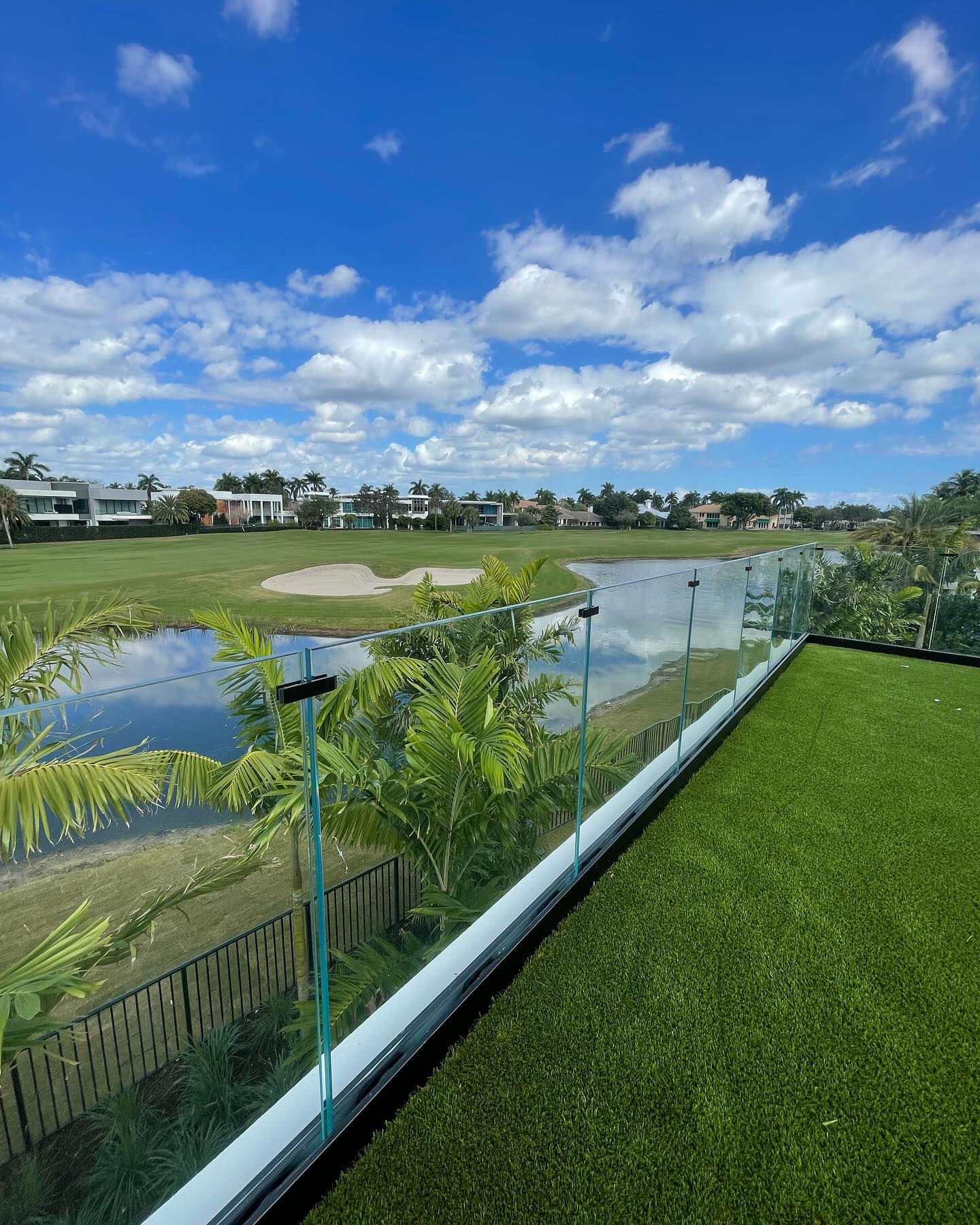 Exterior glass deck railing overlooking a South Florida landscape