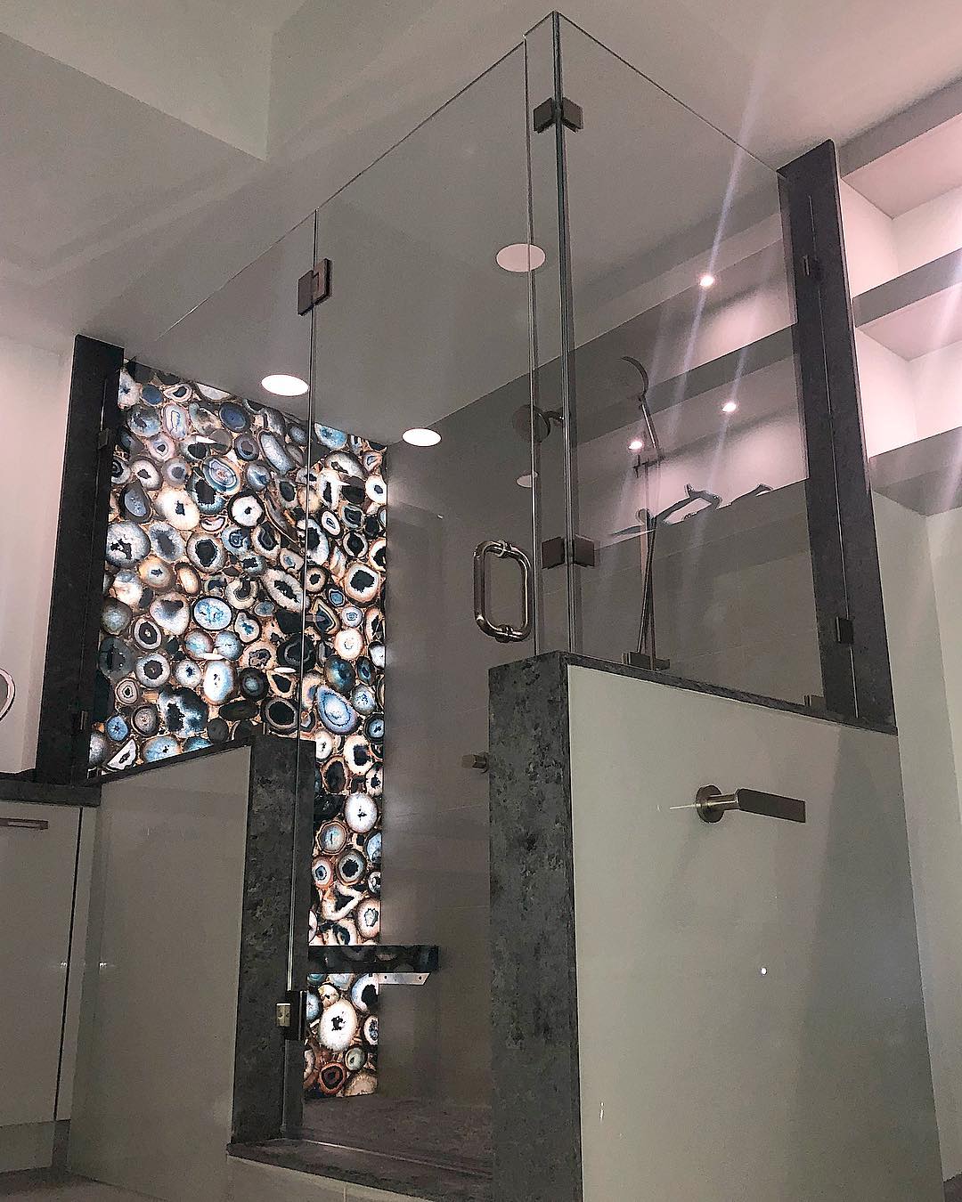 Custom architectural glass installation with illuminated wall details